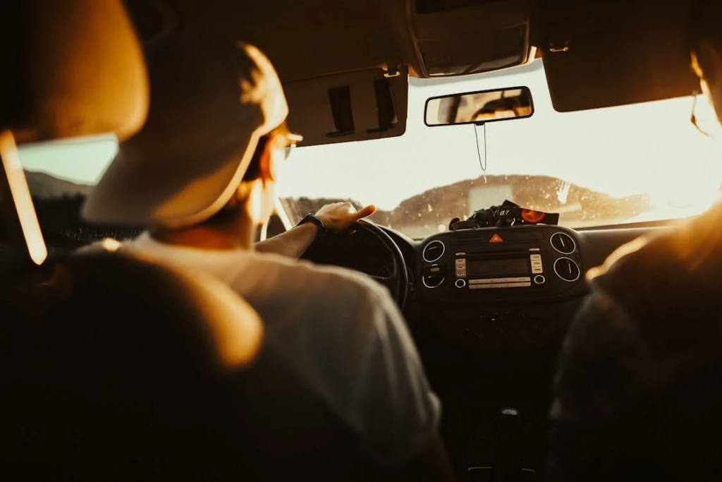 A person driving a car that he rented in Albania. 