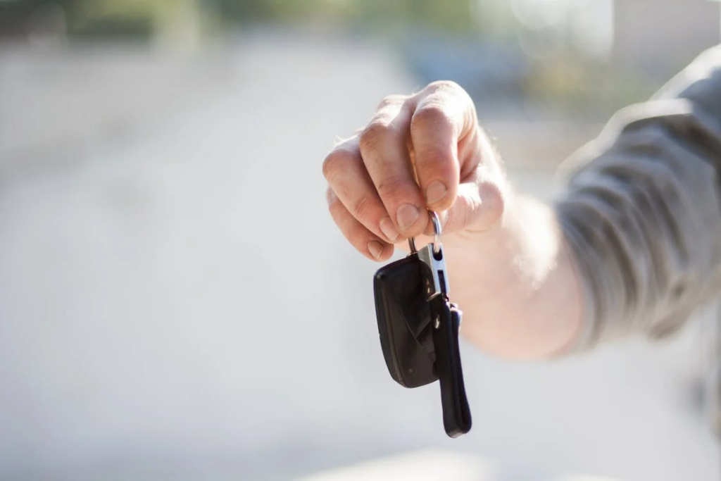 Handling the keys of a rental car in Tirana. 