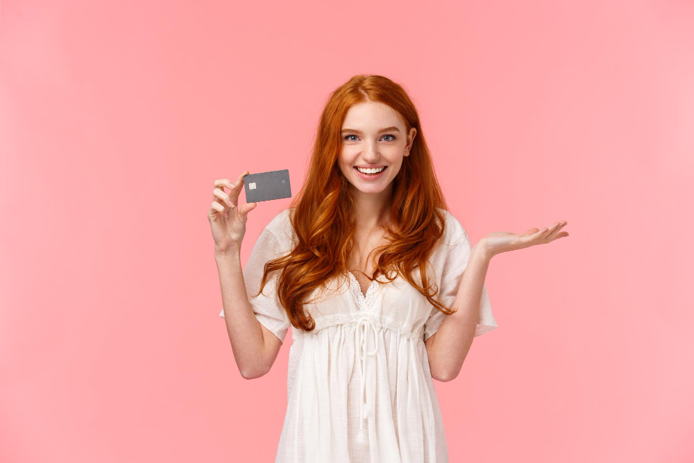 Woman posing with a credit card. 